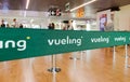 Green belt barrier with white Vueling airlines logo