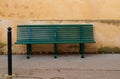 green bench against a yellow wall in aix-en-provence Royalty Free Stock Photo