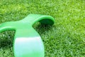 Green bench seat chair in three legs design on the green grass field Royalty Free Stock Photo