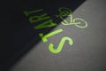 green bicycle symbol with lettering start painted on inner city asphalt surface. Royalty Free Stock Photo