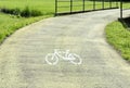 Green bicycle track with white sign. Royalty Free Stock Photo