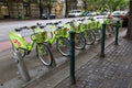 Green bicycles from MOL BuBi docking by street in Budapest, Hungary. It is a bicycle sharing network in Hungary Royalty Free Stock Photo