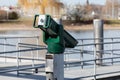 Green binoculars at a ski pier without people, by day