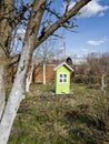 green birdhouse sunny day nature spring blue sky clouds Royalty Free Stock Photo