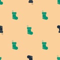 Green and black Christmas stocking icon isolated seamless pattern on beige background. Merry Christmas and Happy New Royalty Free Stock Photo