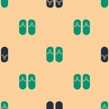 Green and black Flip flops icon isolated seamless pattern on beige background. Beach slippers sign. Vector Illustration Royalty Free Stock Photo