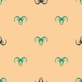 Green and black Head of goat or ram icon isolated seamless pattern on beige background. Mountain sheep. Animal symbol