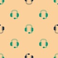 Green and black Headphones icon isolated seamless pattern on beige background. Support customer service, hotline, call