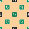 Green and black Human footprint icon isolated seamless pattern on beige background. Trace of human foot. Vector Royalty Free Stock Photo