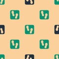 Green and black Human footprints shoes icon isolated seamless pattern on beige background. Shoes sole. Vector Royalty Free Stock Photo