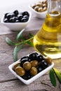 Green and black olives in bowl on a grey wooden background Royalty Free Stock Photo