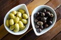 Green and black olives in ceramic pots