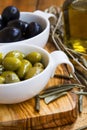 Green and black olives in olive oil on wooden rustic board .Ital Royalty Free Stock Photo