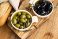 Green and black olives in olive oil on wooden rustic board .Ital Royalty Free Stock Photo