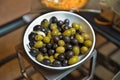 Top view with space for text . Green and black olives in a white ceramic bowl Royalty Free Stock Photo