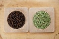 Green and black peppercorns in wooden bowls Royalty Free Stock Photo