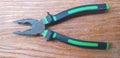 Green black pliers in background wood Royalty Free Stock Photo