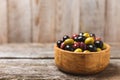 Green, black and red olives, olive oil on a brown wooden background. Royalty Free Stock Photo