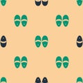 Green and black Slippers icon isolated seamless pattern on beige background. Flip flops sign. Vector Royalty Free Stock Photo