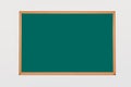 Green blackboard with chalk and eraser on easel with back to school text on isolated background Royalty Free Stock Photo