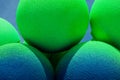 Green and blue balls balloons on cloud sky background. Macro close up image. Vivid holiday poster with copy space. Sunny happy day