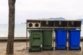 Green and blue bin for different collection Of Recycle Materials on  footpath near beach Royalty Free Stock Photo