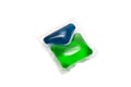 Green and blue gel capsules with laundry detergent Royalty Free Stock Photo