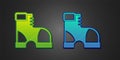Green and blue Hunter boots icon isolated on black background. Vector