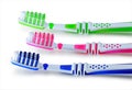 Green, blue and pink toothbrushes are isolated on a white Royalty Free Stock Photo