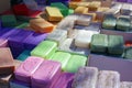 Green blue purple yellow and red soap at a farmer market in France, Europe. Italian hand made soap. Street French market at Nice.