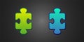 Green and blue Puzzle pieces toy icon isolated on black background. Vector Royalty Free Stock Photo