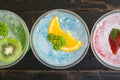 Green Blue Red Italian Soda Cold Beverage and Kiwi Lemon Strawberry Fruit Close Up Royalty Free Stock Photo