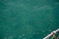 Green blue sea water surface and yacht tackle top view photo. Still sea surface with wind ripples. Idyllic cruise banner Royalty Free Stock Photo