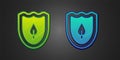 Green and blue Shield with leaf icon isolated on black background. Eco-friendly security shield with leaf. Vector Royalty Free Stock Photo