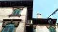 Green-blue shutters on historical building and vintage metal light  on the blue sky background Royalty Free Stock Photo