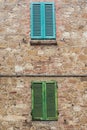 Green and Blue shutters on stone wall