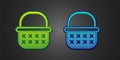 Green and blue Wicker basket icon isolated on black background. Vector