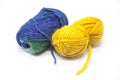 Green blue and yellow ball of wool yarn for knitting close up on a white background