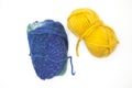 Green blue and yellow ball of wool yarn for knitting close up on a white background