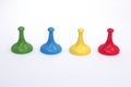 Green, blue, yellow, red game piece movers Royalty Free Stock Photo