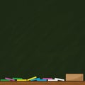 Green board background with multi-colored chalk and wood eraser. Royalty Free Stock Photo