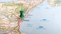 A green board pin stuck in Catania on a map of Sicily Royalty Free Stock Photo