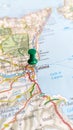 A green board pin stuck in Catania on a map of Sicily portrait Royalty Free Stock Photo