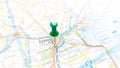 A green board pin stuck in Padova on a map of Italy