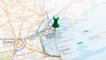 A green board pin stuck in Venice on a map of Italy