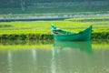 A green boat without passengers was parked on the edge of the lake Royalty Free Stock Photo