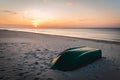 Green boat on sandy Baltic sea beach in sunset time. Nida, Lithuania