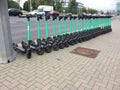 Green Bolt electric scooters lined up on street in Vilnius