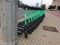 Green Bolt electric scooters lined up on street in Vilnius