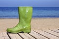 Green boot on beach unlucky fisherman metaphor